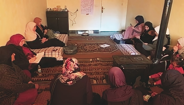 A group of refugee parents practicing HeartMath